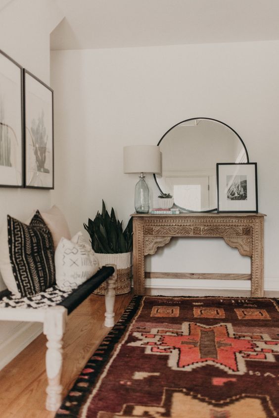 A Boho Style Entryway With A Vintage Encrusted Console