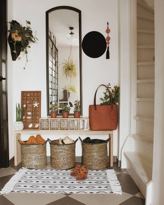 An Earthy-Tone Entryway With A Tall Mirror, Baskets